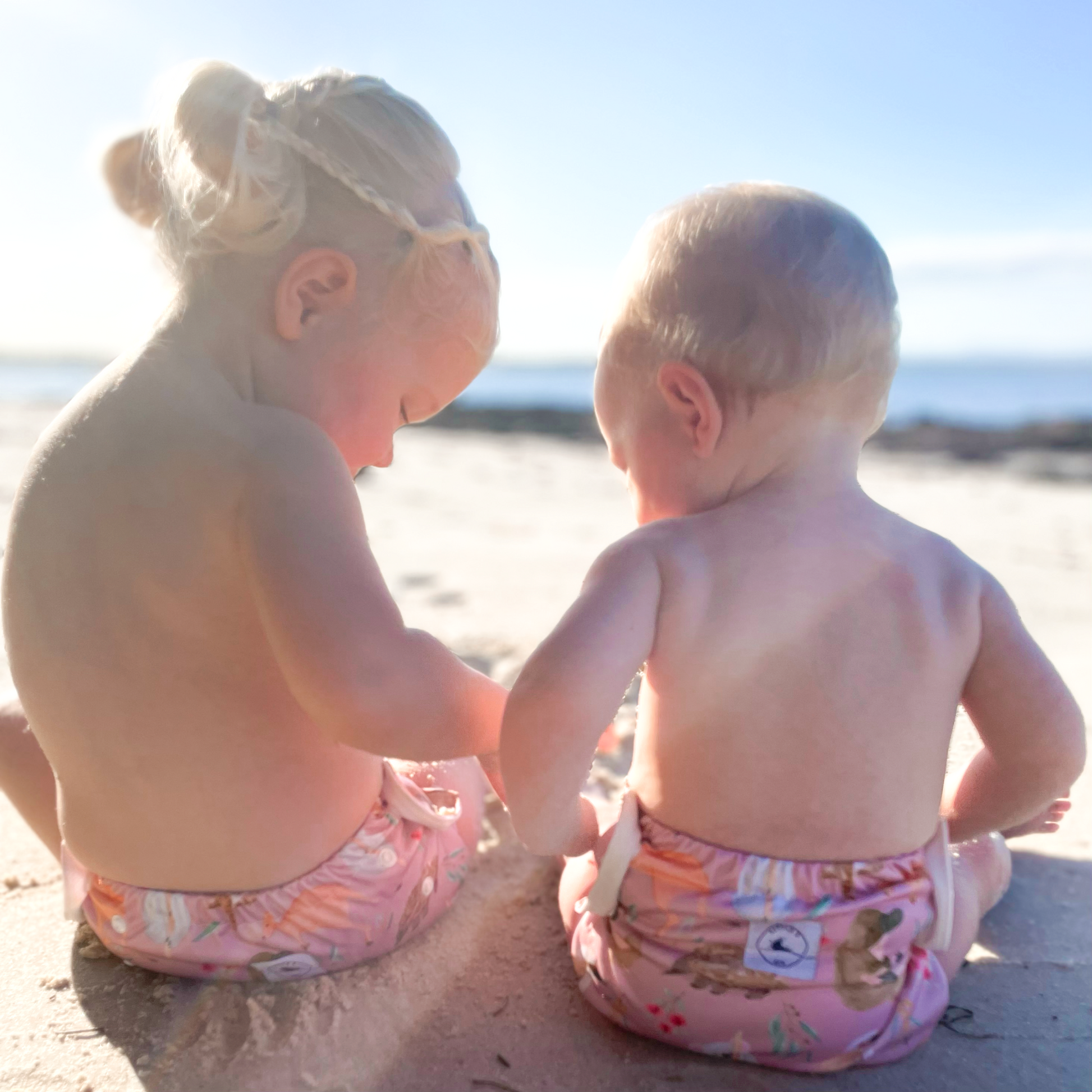 LITTLE E & CO – kids swim nappy, a pale pink with a colourful Australian animals print featuring koalas, kangaroos, platypus, kookaburras and echidnas. The swim nappy is a one size fits most design and has 3 adjustable snap settings.