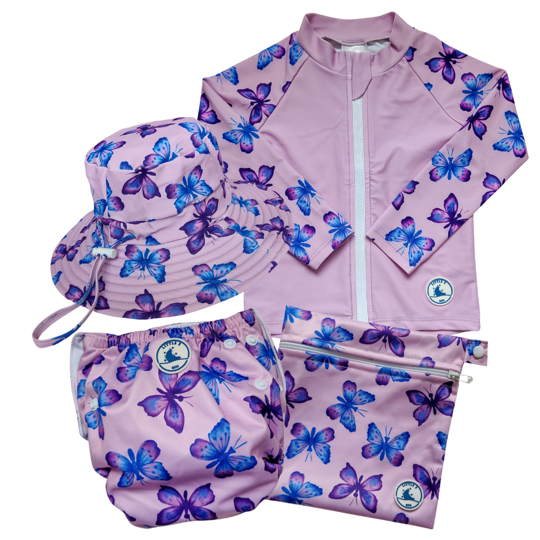 LITTLE E & CO - four-piece kids' swim set featuring a long-sleeve rash guard, swim hat, swim nappy and wet bag. The set a pastel purple with a colourful pink, blue and purple butterflies. Made with UPF 50+ sun protection fabric. The rash guard has a front zipper for easy wear, and the swim nappy has adjustable snaps, and the hat has adjustable toggles.