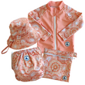 Baby Swimwear Set in peach pink with contemporary indigenous print, featuring UPF 50+ long sleeve rashie with front zipper, adjustable swim nappy, sun hat with toggles, and matching wet bag.