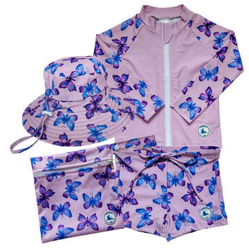 LITTLE E & CO - four-piece kids' swim set featuring a long-sleeve rash guard, swim hat, swim shorts and wet bag. The set is a pastel purple with a colourful pink, blue and purple butterflies.. Made with UPF 50+ sun protection fabric. The rash guard has a front zipper for easy wear, and the shorts feature an adjustable drawstring waistband for a secure fit, and the hat has adjustable toggles.