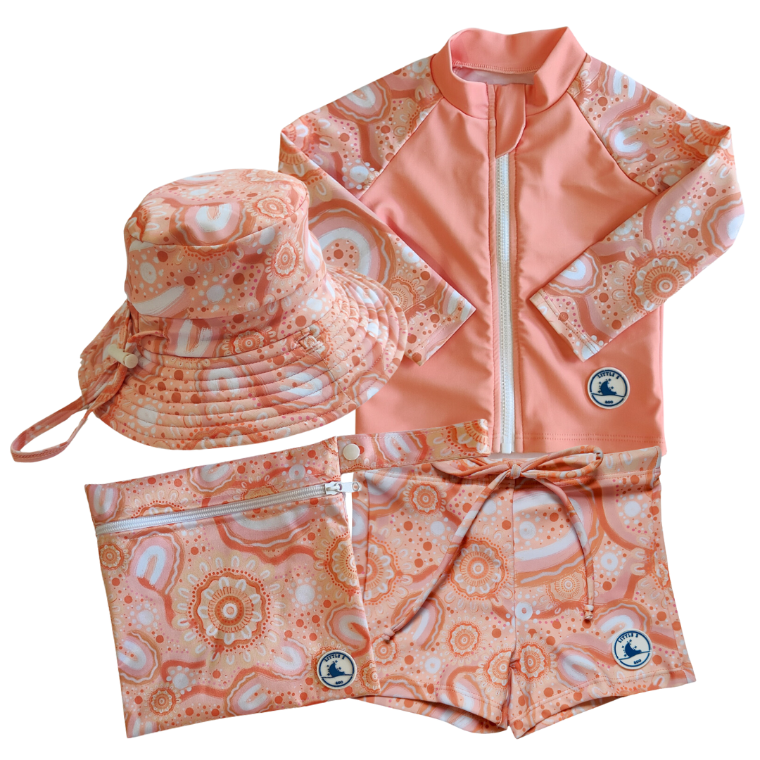 LITTLE E & CO - four-piece kids' swim set featuring a long-sleeve rash guard, swim hat, swim shorts and wet bag. The set is a peach pink with a colourful contemporary indigenous print. Made with UPF 50+ sun protection fabric. The rash guard has a front zipper for easy wear, and the shorts feature an adjustable drawstring waistband for a secure fit, and the hat has adjustable toggles.
