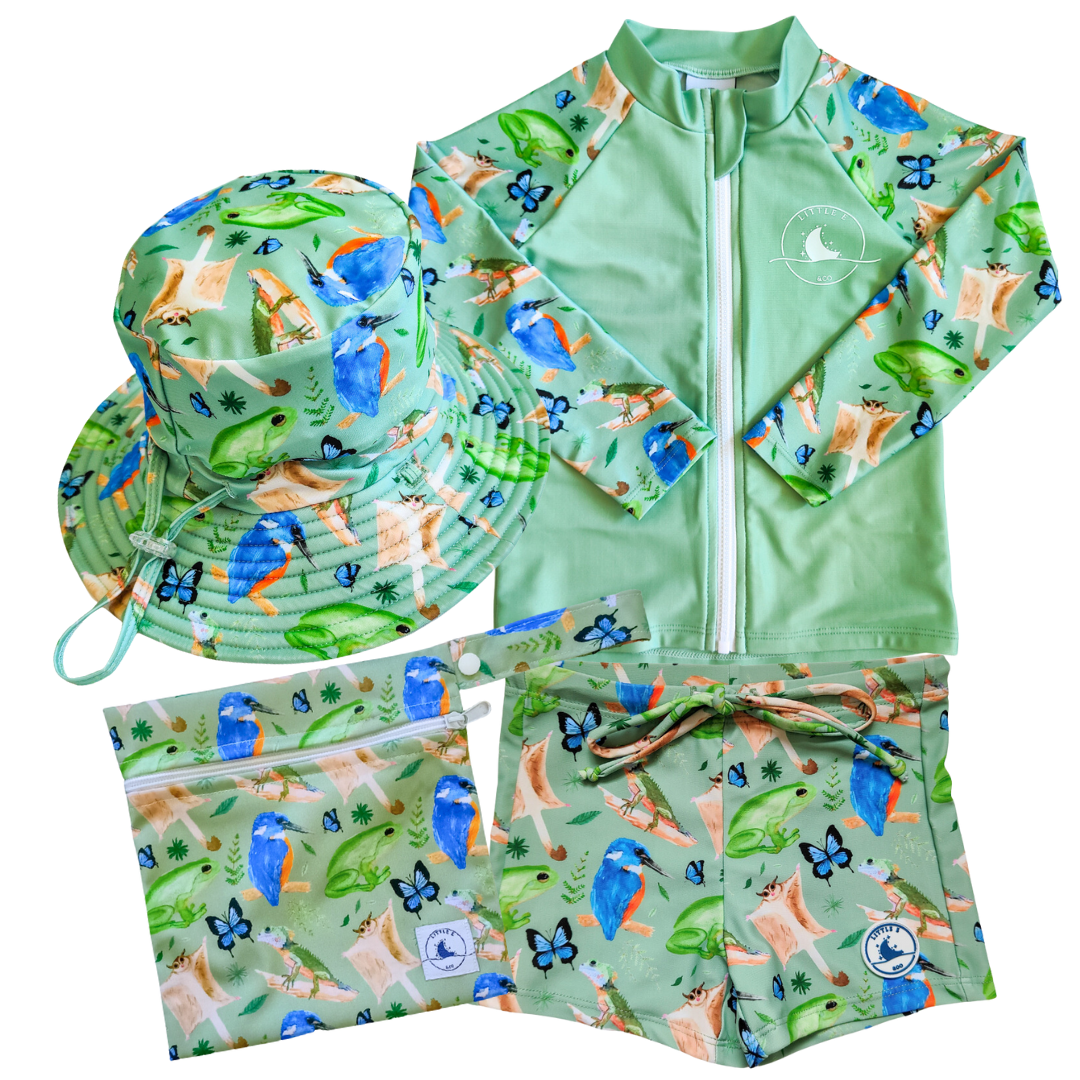 LITTLE E & CO - four-piece kids' swim set featuring a long-sleeve rash guard, swim hat, swim shorts and wet bag. The set is green with a colourful rainforest print featuring birds, frogs, lizards and butterflies . Made with UPF 50+ sun protection fabric. The rash guard has a front zipper for easy wear, and the shorts feature an adjustable drawstring waistband for a secure fit, and the hat has adjustable toggles.