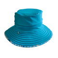 LITTLE E & CO – kids swim hat, a turquoise blue with a colourful contemporary indigenous print. Made with UPF 50+ sun protection fabric. The swim hat features adjustable toggles.