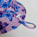 LITTLE E & CO – kids swim hat, a pastel purple with a colourful pink, blue and purple butterflies. Made with UPF 50+ sun protection fabric. The swim hat features adjustable toggles