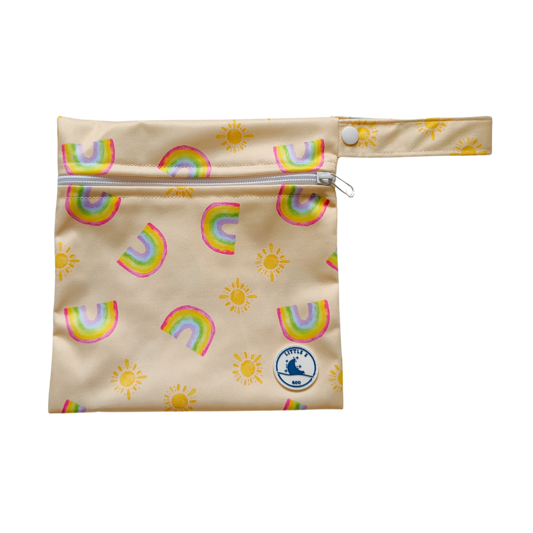 Mini wet bag in pale yellow with rainbow and sun print, made from waterproof PUL and designed with a convenient strap.