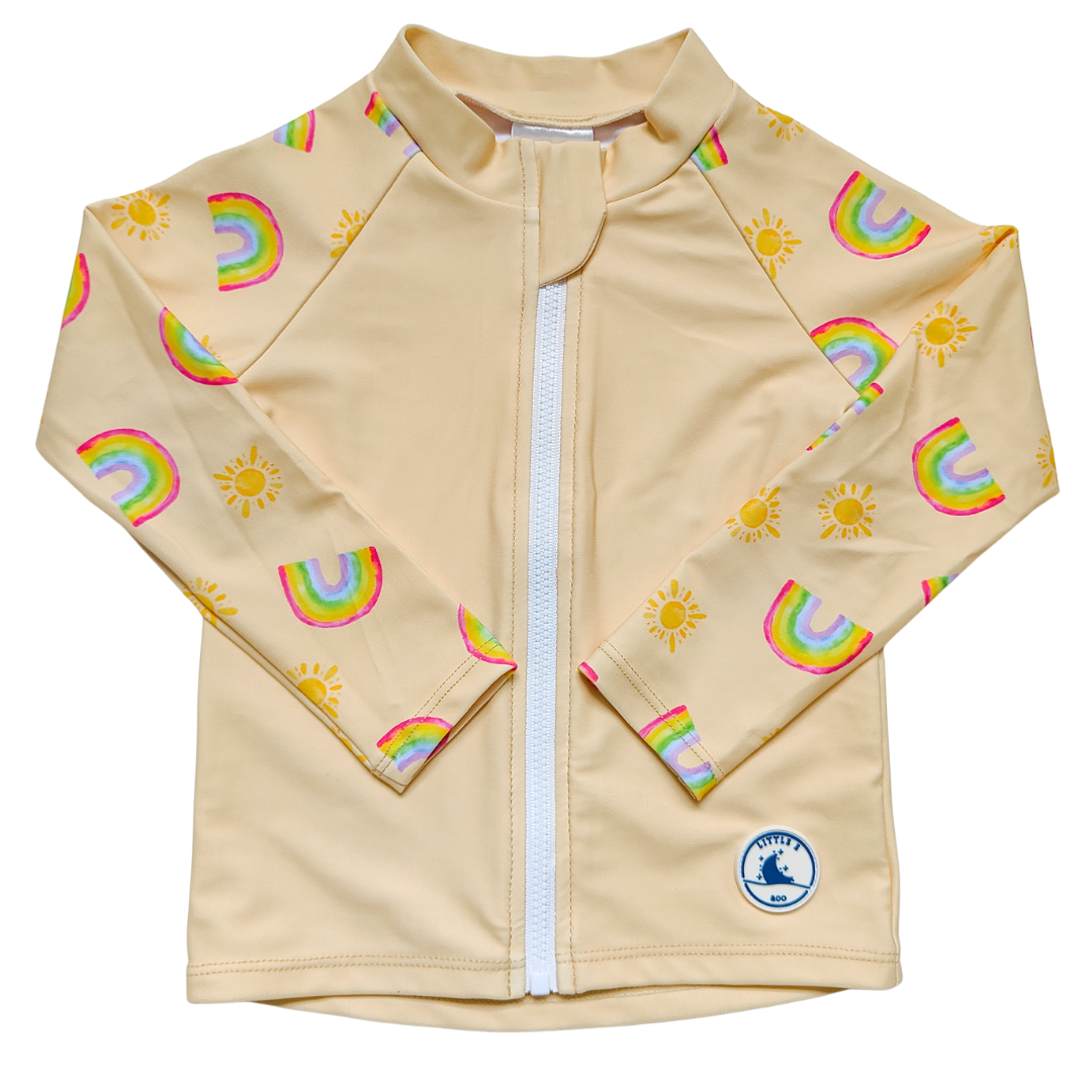 Children's rashie in pale yellow with rainbow and sun print, made from UPF 50+ sun protection fabric with front zipper.