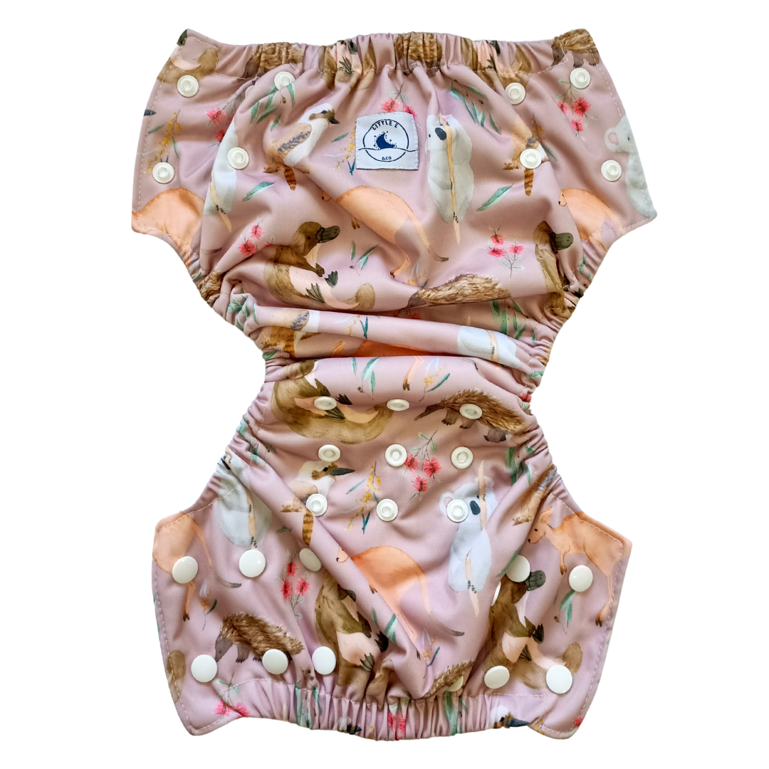 LITTLE E & CO – kids swim nappy, a pale pink with a colourful Australian animals print featuring koalas, kangaroos, platypus, kookaburras and echidnas. The swim nappy is a one size fits most design and has 3 adjustable snap settings.