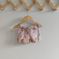 Kids swim shorts in pale pink with Australian animals print, featuring koalas, kangaroos, platypus, kookaburras, and echidnas, made with UPF 50+ fabric and adjustable drawstring waistband.