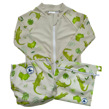 Children's swimwear set with green crocodile pattern on a white background