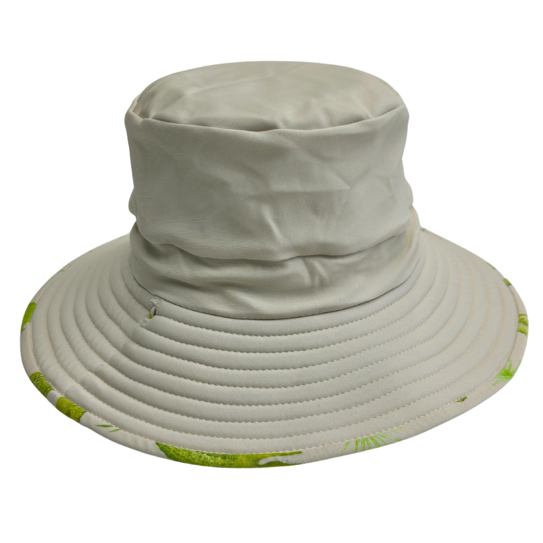 Beige bucket hat with green floral pattern on a white background