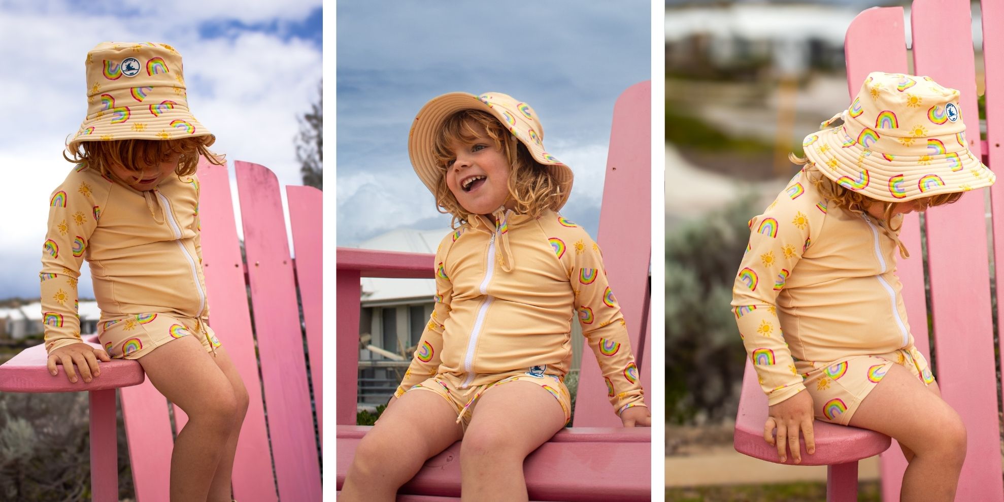 Child wearing a yellow kids swimwear with rainbow patterns on a pink chair against a blue sky.slider_item_f4Knzw