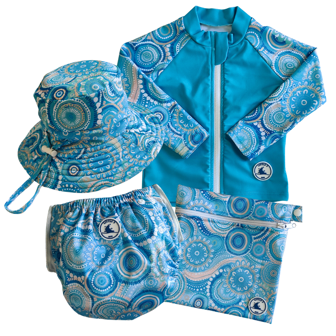 LITTLE E & CO - four-piece kids' swim set featuring a long-sleeve rash guard, swim hat, swim nappy and wet bag. The set is a turquoise blue with a colourful contemporary indigenous print. Made with UPF 50+ sun protection fabric. The rash guard has a front zipper for easy wear, and the swim nappy has adjustable snaps, and the hat has adjustable toggles.