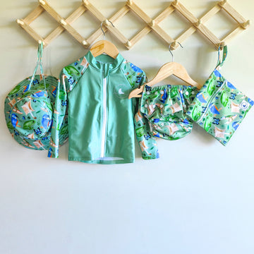 Baby Swimwear Set in green rainforest print with UPF 50+ long sleeve rashie, adjustable swim nappy, sun hat with toggles, and matching wet bag.

