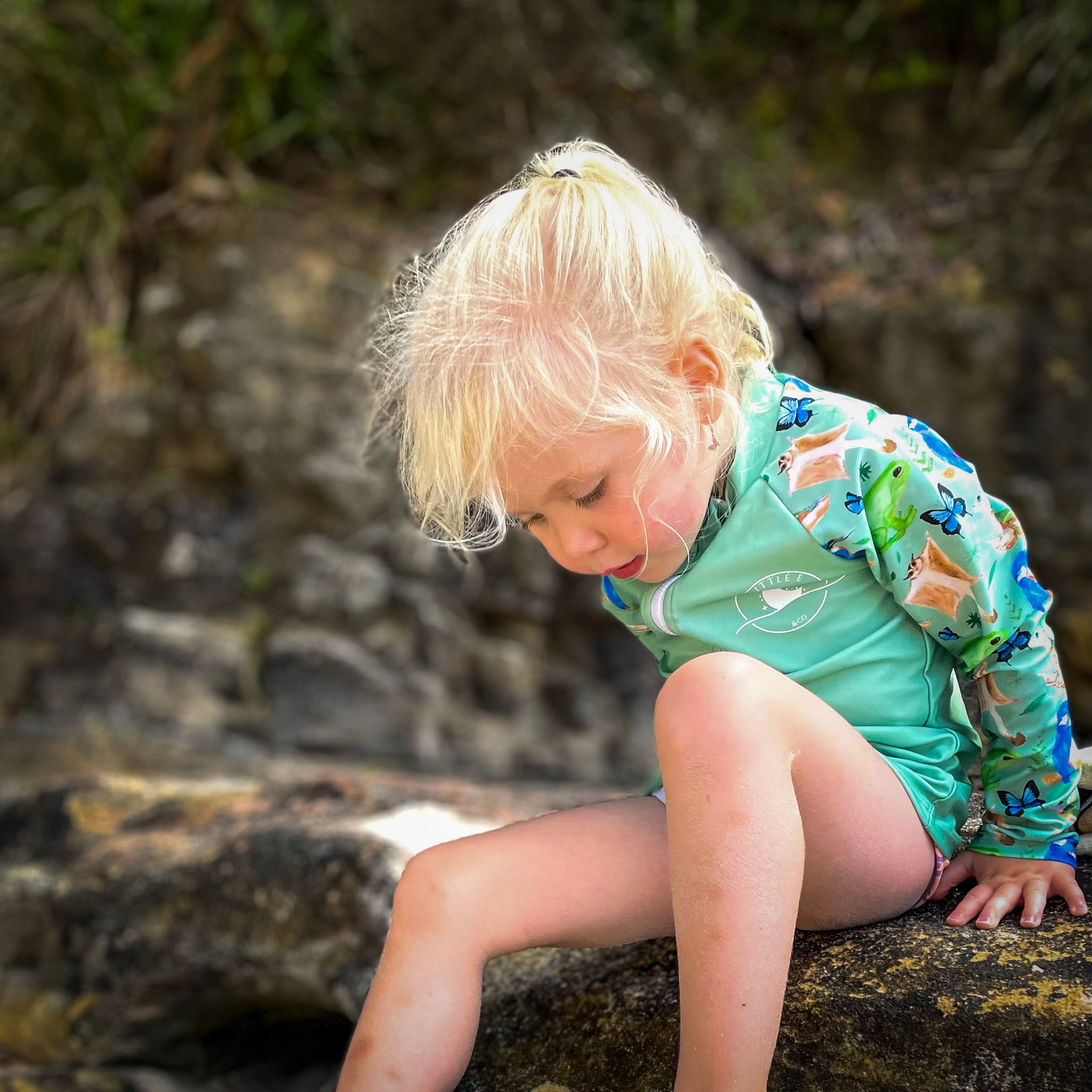 Kids long sleeve rashie in green rainforest print with UPF 50+ sun protection and front zipper.