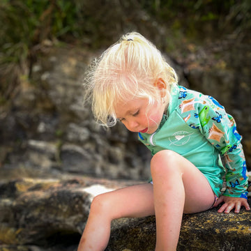Kids long sleeve rashie in green rainforest print with UPF 50+ sun protection and front zipper.