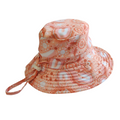 LITTLE E & CO – kids swim hat, a peach pink with a colourful contemporary indigenous print. Made with UPF 50+ sun protection fabric. The swim hat features adjustable toggles.