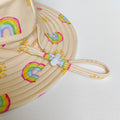 LITTLE E & CO – kids swim hat, a pale yellow with a colourful rainbow and sun print. Made with UPF 50+ sun protection fabric. The swim hat features adjustable toggles