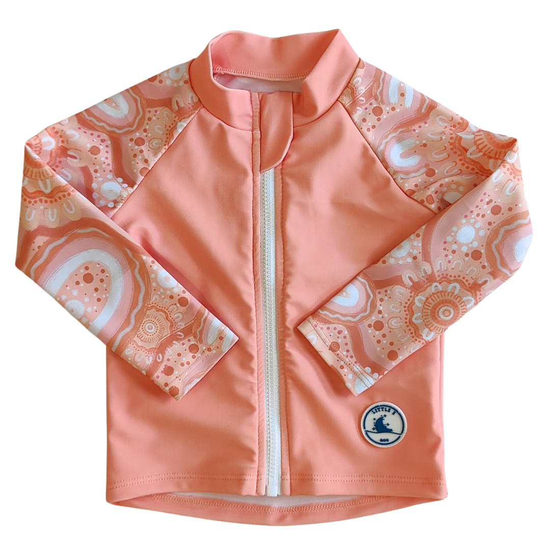 LITTLE E & CO - four-piece kids' swim set featuring a long-sleeve rash guard, swim hat, swim shorts and wet bag. The set is a peach pink with a colourful contemporary indigenous print. Made with UPF 50+ sun protection fabric. The rash guard has a front zipper for easy wear, and the shorts feature an adjustable drawstring waistband for a secure fit, and the hat has adjustable toggles.