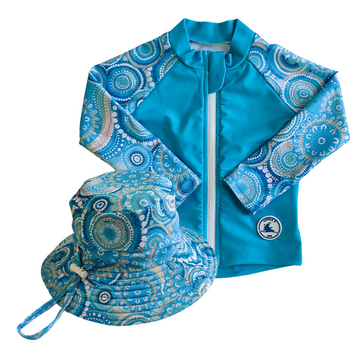 LITTLE E & CO - Two-piece kids' swim set featuring a long-sleeve rash guard and swim hat. The set is a turquoise blue with a colourful contemporary indigenous print. Made with UPF 50+ sun protection fabric. The rash guard has a front zipper for easy wear, and the hat features adjustable toggles.