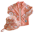 LITTLE E & CO - Two-piece kids' swim set featuring a long-sleeve rash guard and swim hat. The set is a peach pink with a colourful contemporary indigenous print. Made with UPF 50+ sun protection fabric. The rash guard has a front zipper for easy wear, and the hat features adjustable toggles.