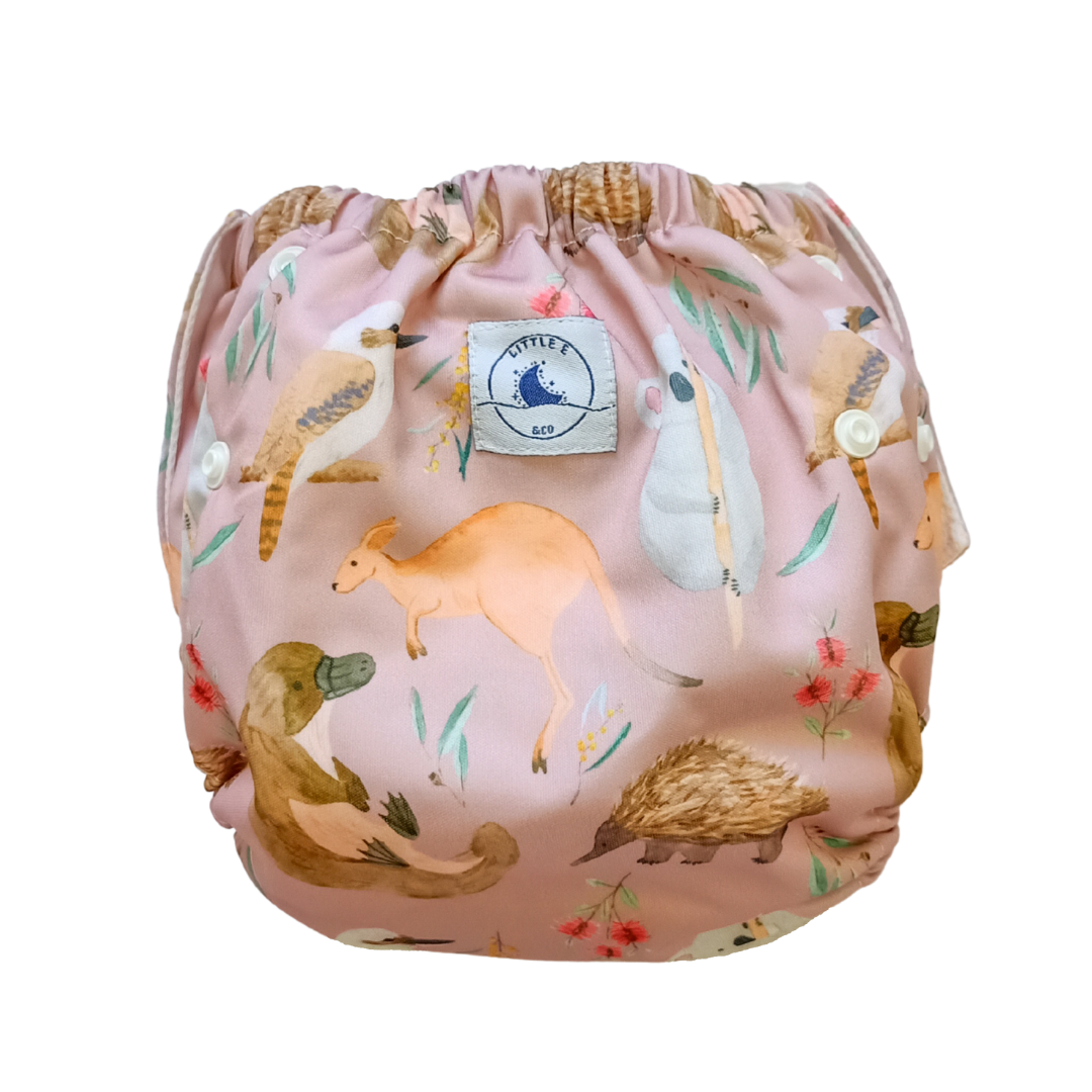 LITTLE E & CO – kids swim nappy, a pale pink with a colourful Australian animals print featuring koalas, kangaroos, platypus, kookaburras and echidnas. The swim nappy is a one size fits most design and has 3 adjustable snap settings.