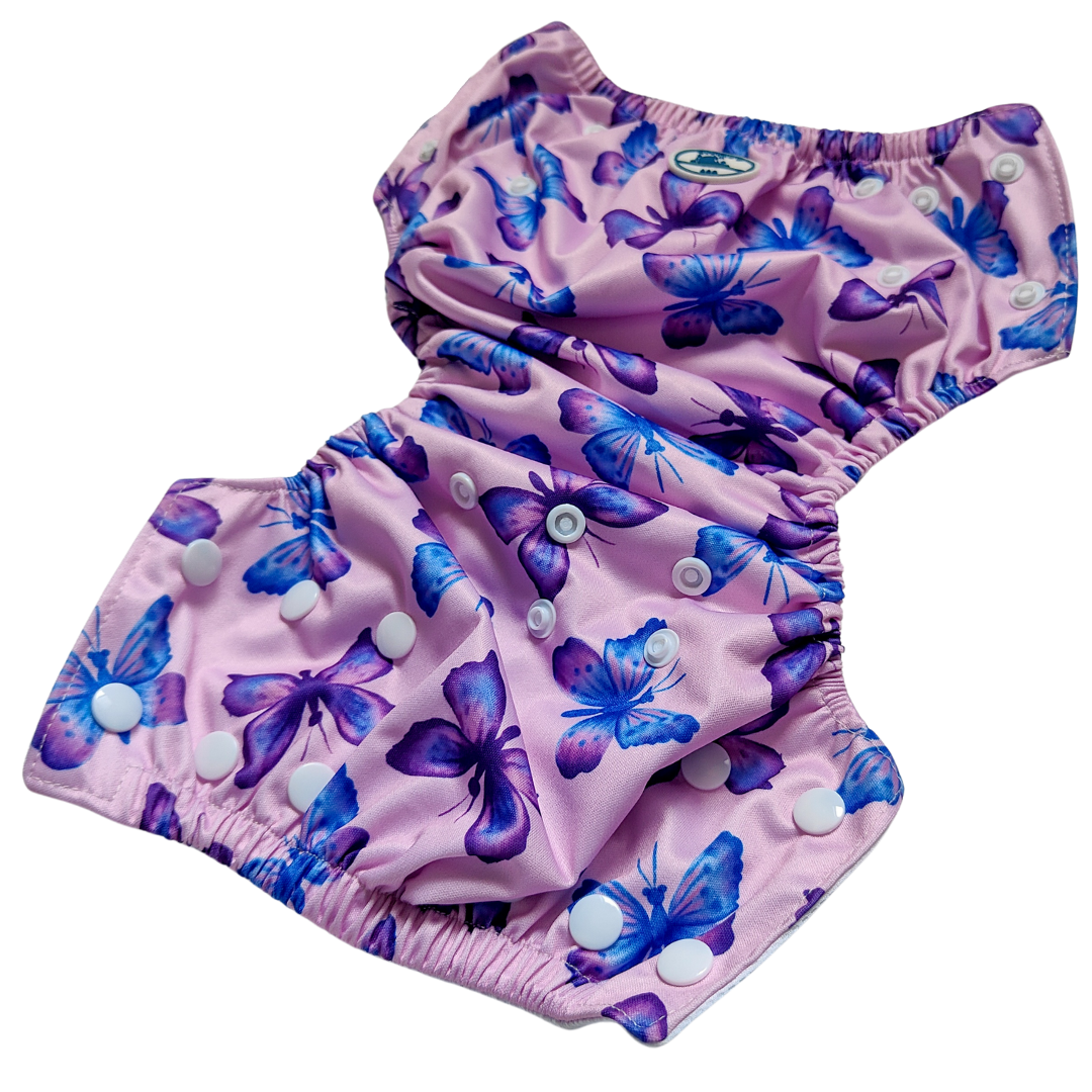 LITTLE E & CO – kids swim nappy, a pastel purple with a colourful pink, blue and purple butterflies. The swim nappy is a one size fits most design and has 3 adjustable snap settings.
