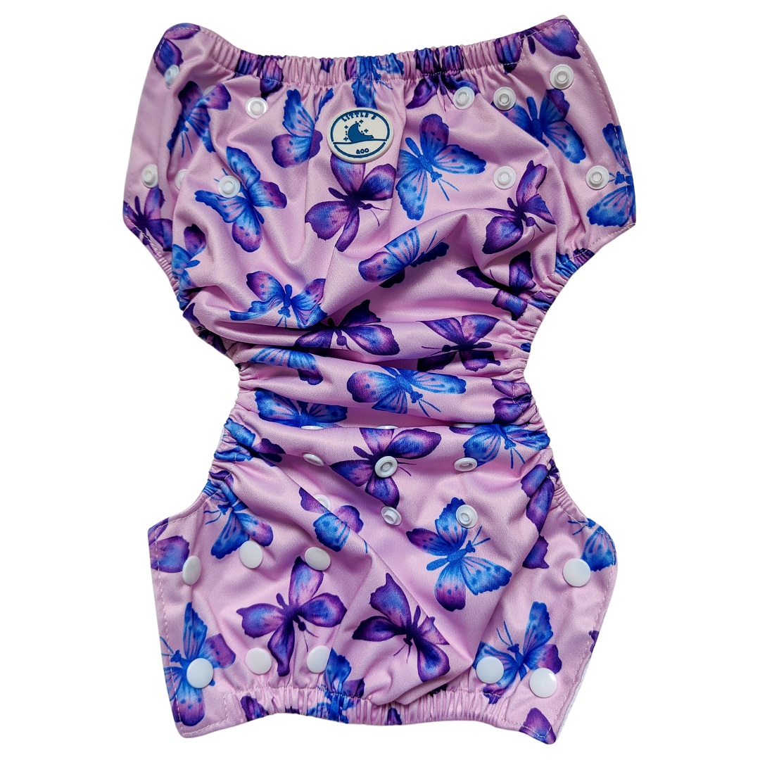 LITTLE E & CO – kids swim nappy, a pastel purple with a colourful pink, blue and purple butterflies. The swim nappy is a one size fits most design and has 3 adjustable snap settings.