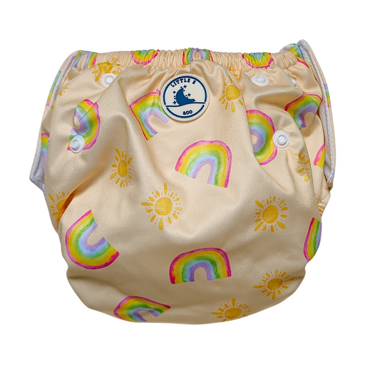 LITTLE E & CO – kids swim nappy, a pale yellow with a colourful rainbow and sun print. The swim nappy is a one size fits most design and has 3 adjustable snap settings.