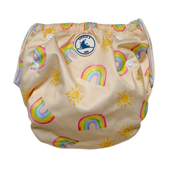 Reusable swim nappy in Rainbows print, a pale yellow design with a colourful rainbow and sun