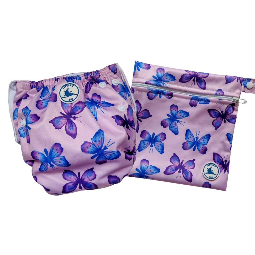 LITTLE E & CO – Two-piece kids' swim set, includes a swim nappy and wet bag, a pastel purple with a colourful pink, blue and purple butterflies. The swim nappy is a one size fits most design and has 3 adjustable snap settings and the wet bag has a strap.