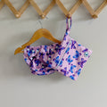LITTLE E & CO – Two-piece kids' swim set, includes a swim nappy and wet bag, a pastel purple with a colourful pink, blue and purple butterflies. The swim nappy is a one size fits most design and has 3 adjustable snap settings and the wet bag has a strap.