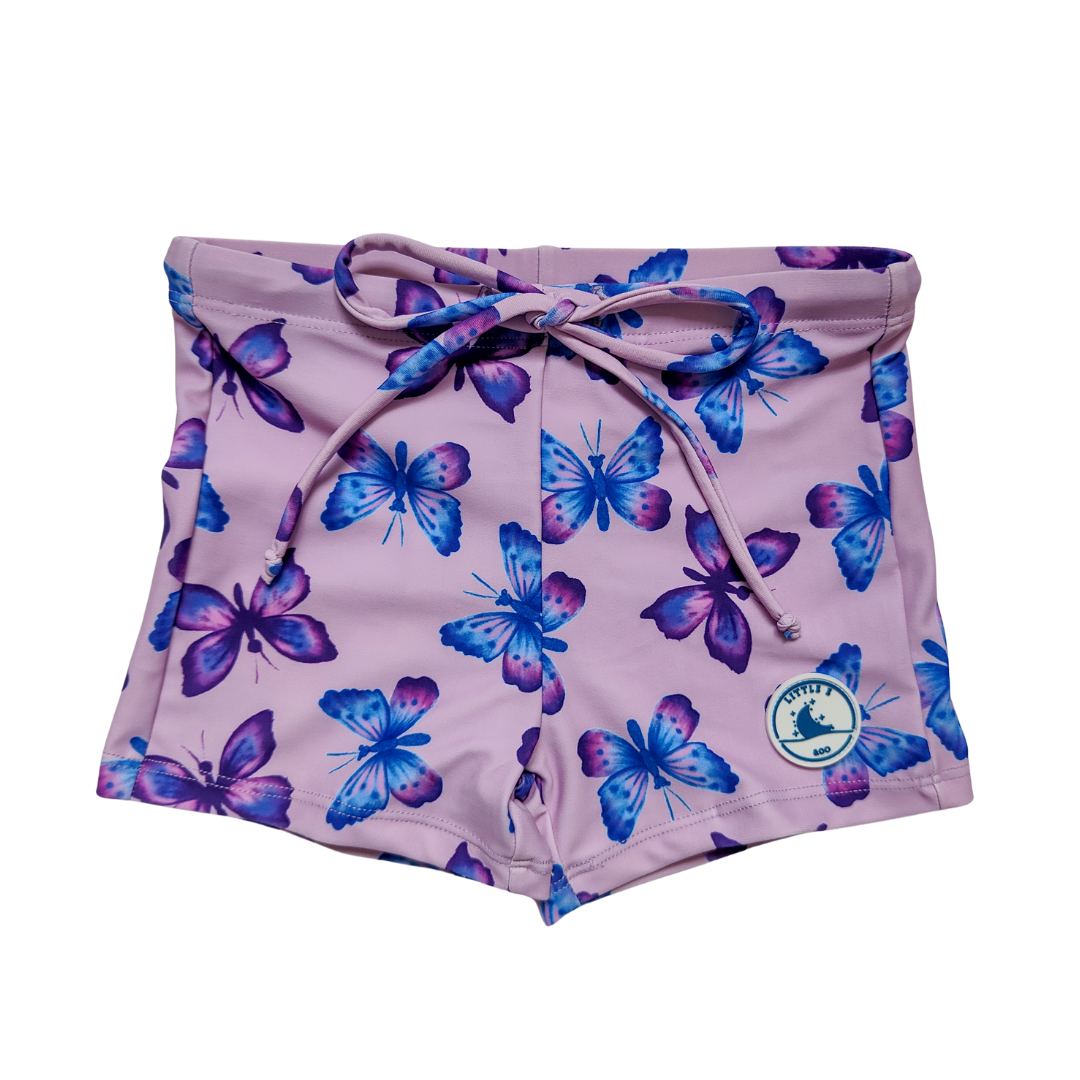 LITTLE E & CO – kids swim shorts, a pastel purple with a colourful pink, blue and purple butterflies. Made with UPF 50+ sun protection fabric. The shorts feature an adjustable drawstring waistband for a secure fit