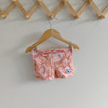 LITTLE E & CO – kids swim shorts, peach pink with a colourful contemporary indigenous print. Made with UPF 50+ sun protection fabric. The shorts feature an adjustable drawstring waistband for a secure fit.