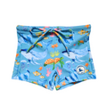 LITTLE E & CO – kids swim shorts, The set is blue with a colourful ocean print featuring whales, turtles, fish and coral. Made with UPF 50+ sun protection fabric. The shorts feature an adjustable drawstring waistband for a secure fit