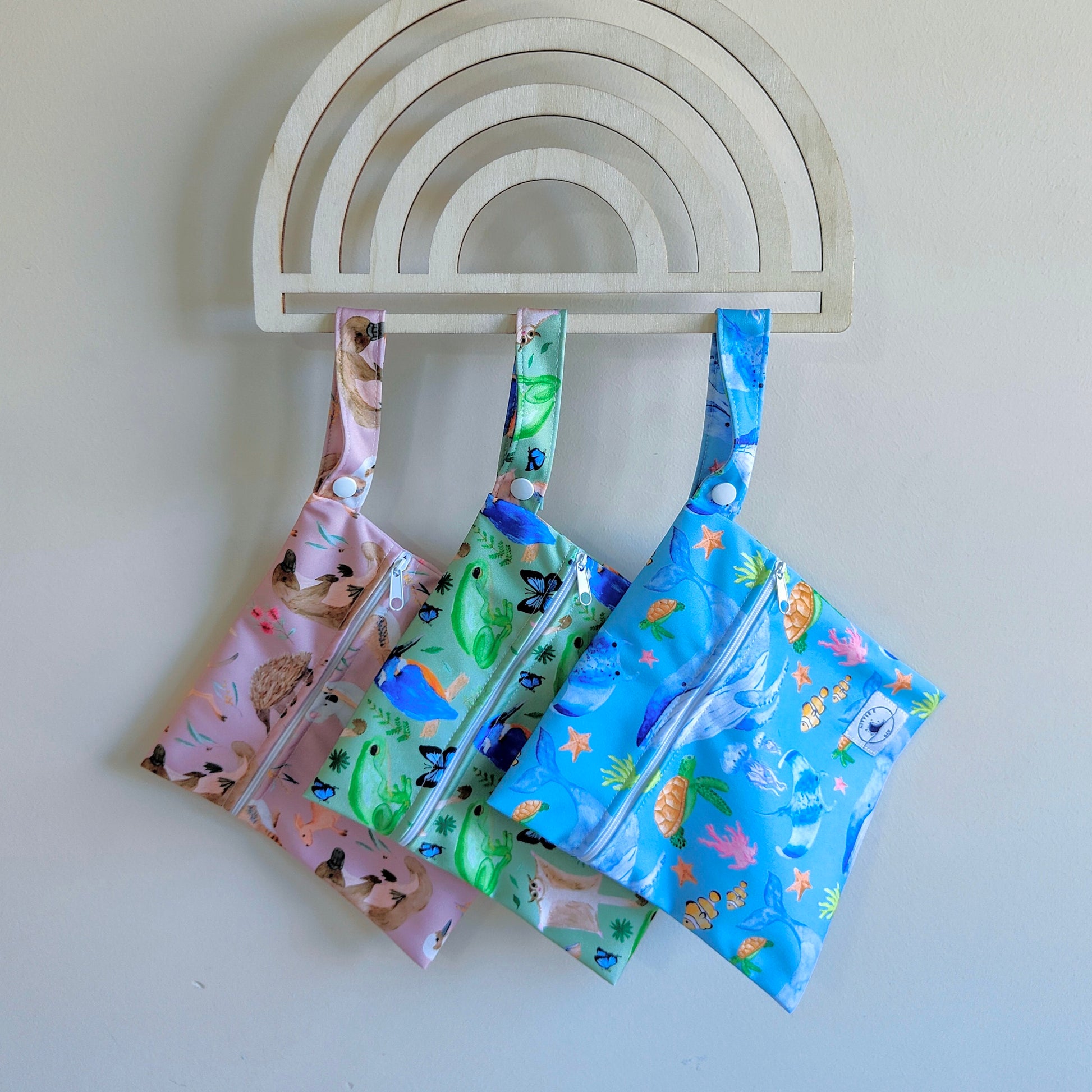 Mini wet bag with fun, colourful print, made from waterproof PUL and features a handy strap.

